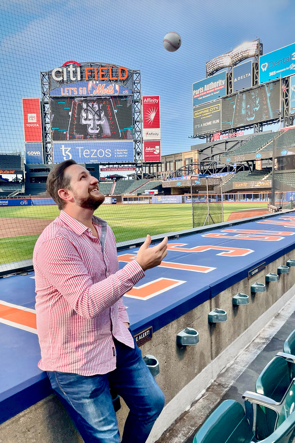 John DeMarsico tosses a baseball in the air
