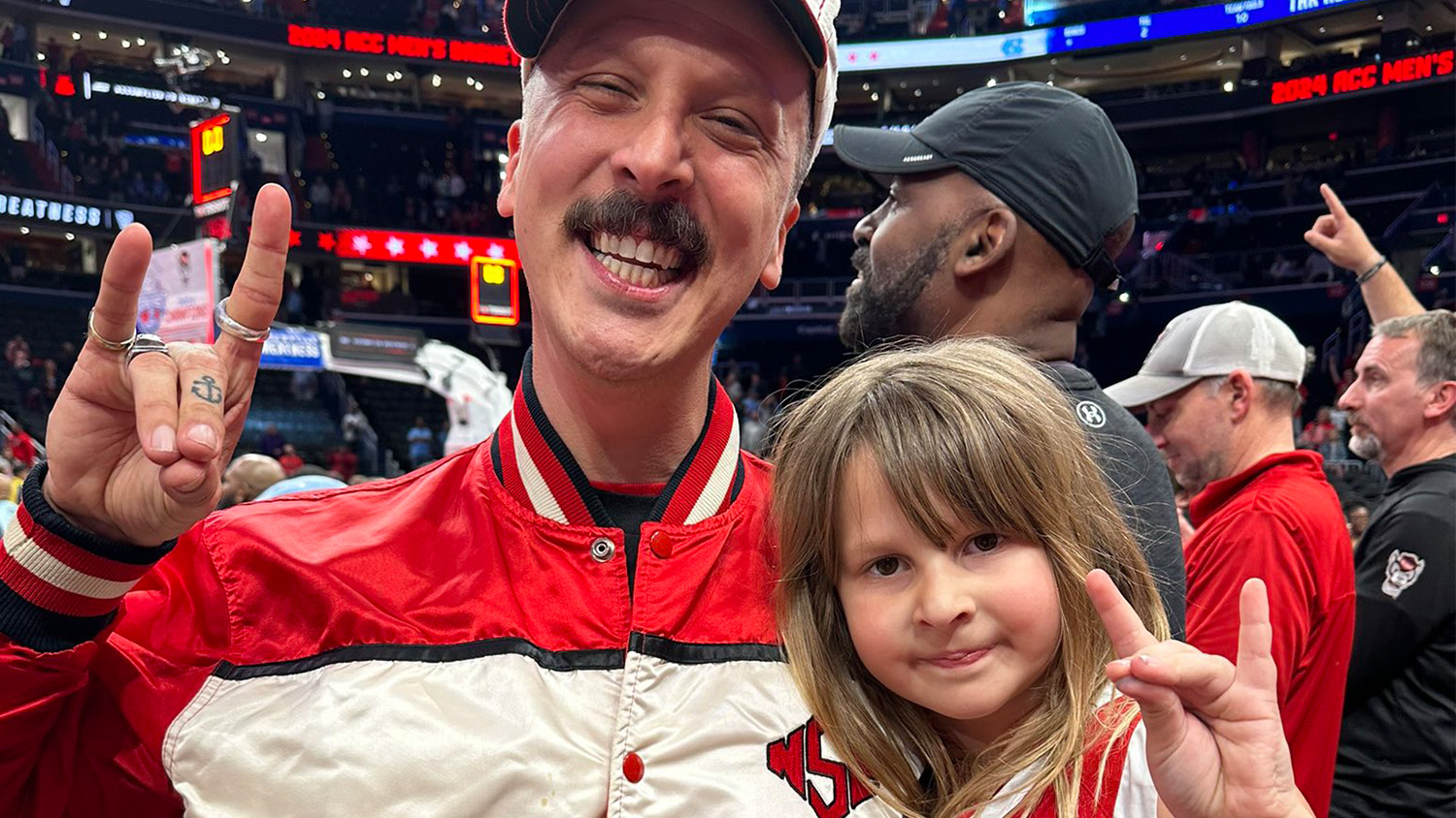 American Aquarium frontman BJ Barham celebrates NC State basketball's first ACC Tournament championship in 37 years with his daughter, Pearl.