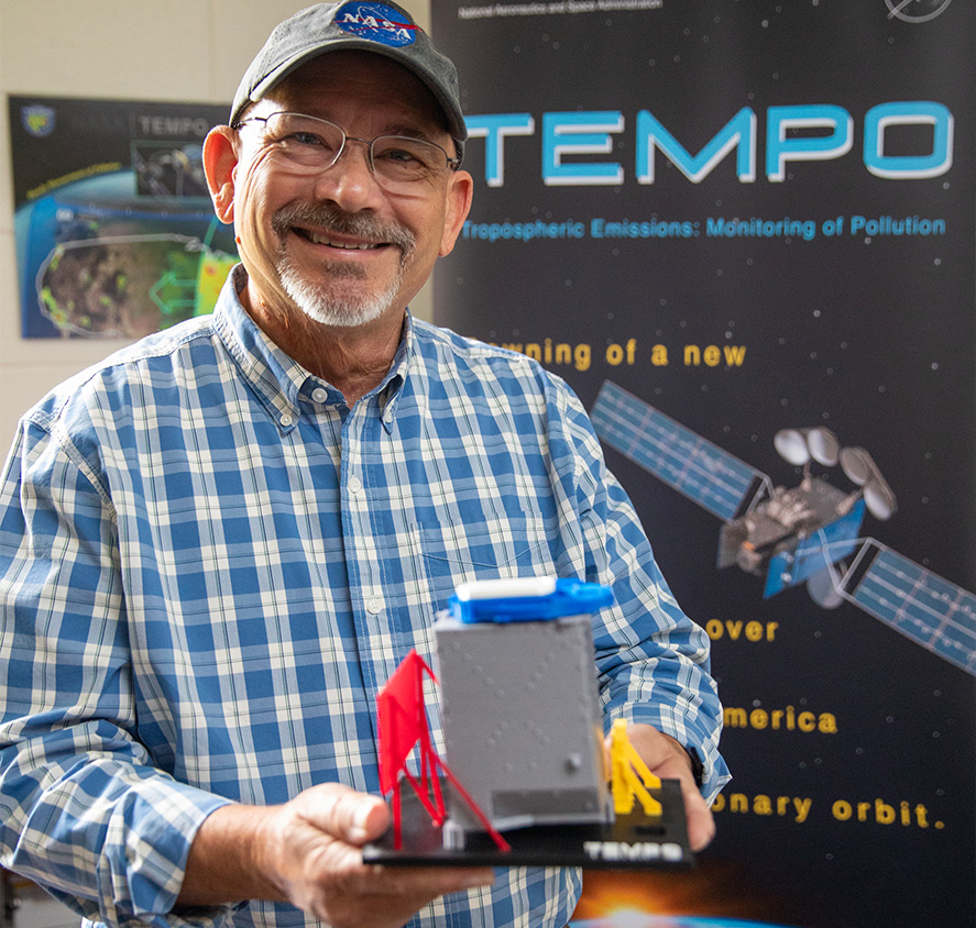 NASA's Robert Neece holds a TEMPO spectrometer that will be on a satellite measuring air pollution from Mexico to northern Canada.
