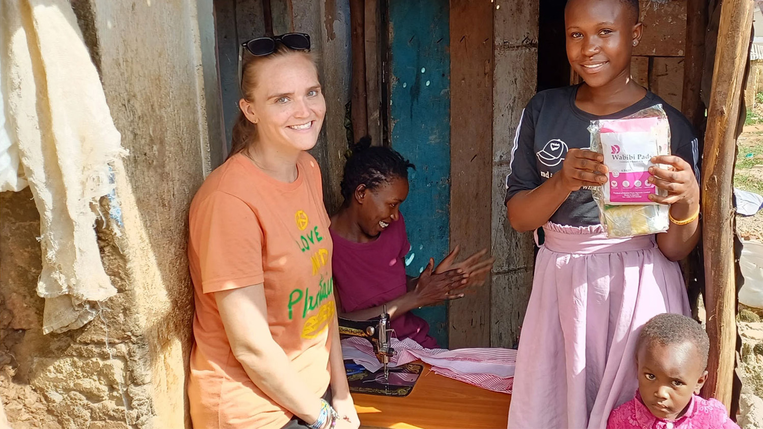 Alex Petercuskie with some young people in Uganda, where she co-founded Lift One Kin.