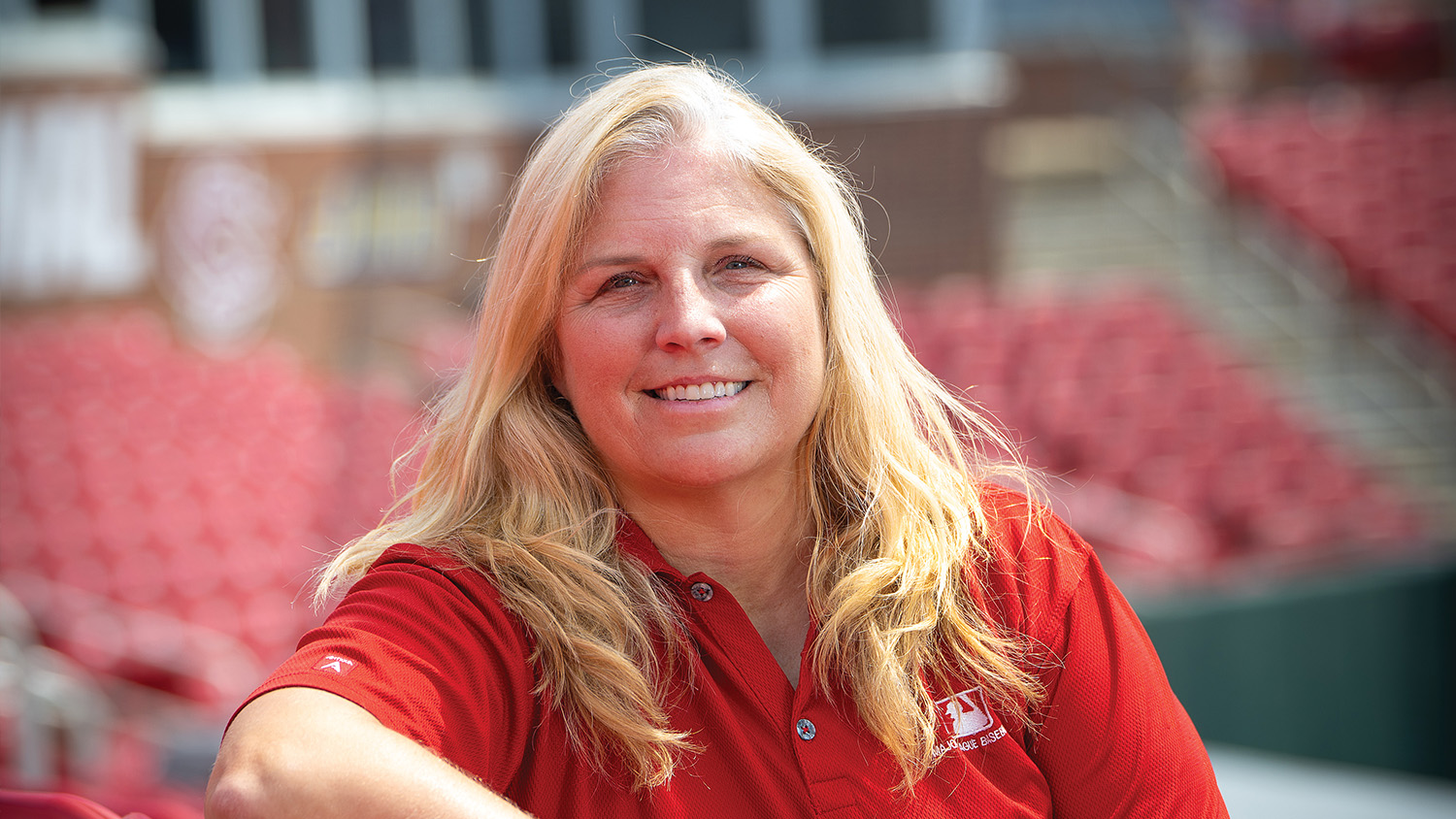 MLB scout Christie Wood sits on NC State's campus in Dail Park at Doak Field.