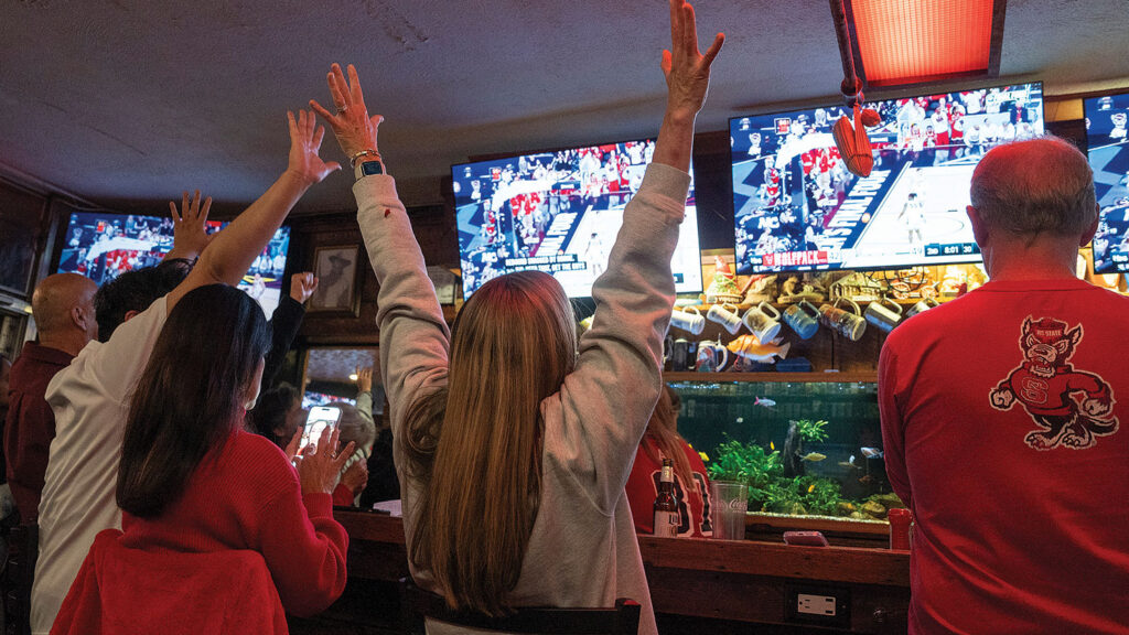 Wolfpack fans celebrate in a bar. 