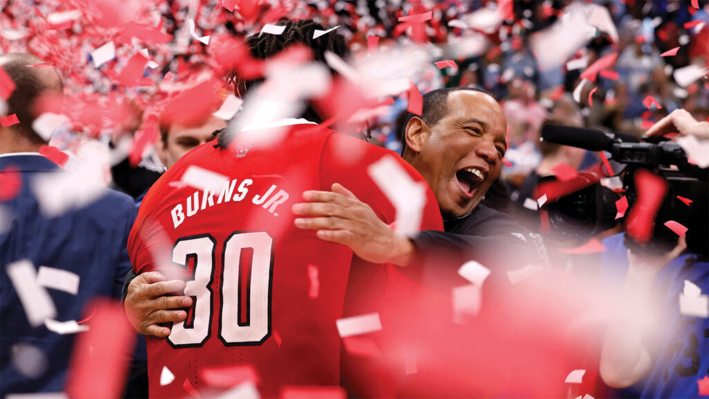 Kevin Keatts hugs DJ Burns.