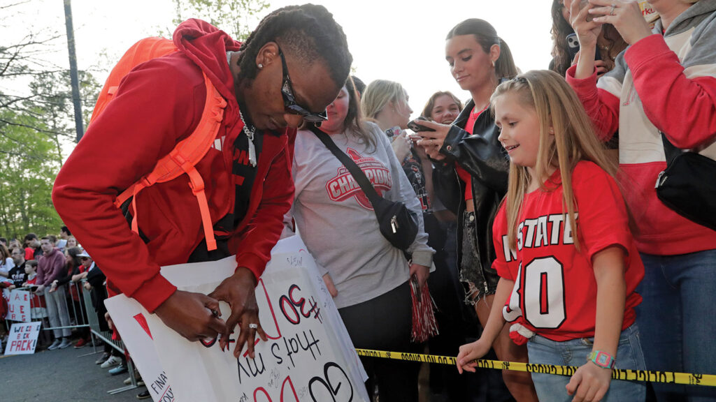 DJ Horne autographs a sign for a fan. 
