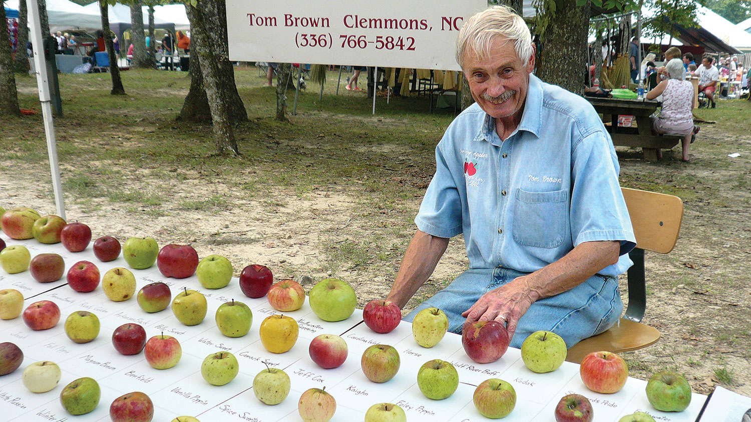 Tom Brown ’63, ’64 with his heritage apple exhibit at the Mountaineer Folk Festival in Tennessee's Fall Creek Falls State Park.