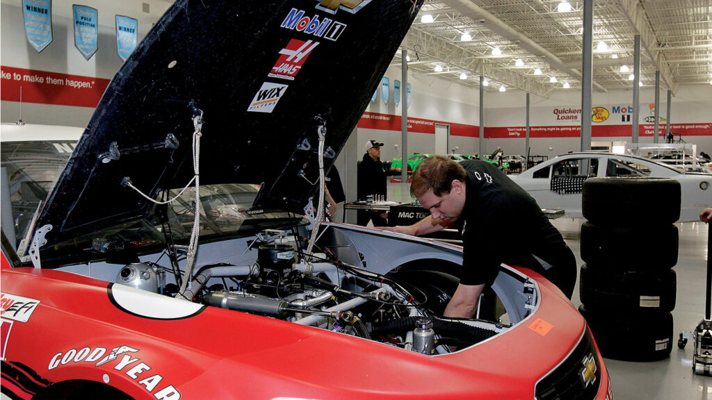 NASCAR race engineer and Wolfpack alum Daniel Knost gathers data on a car.