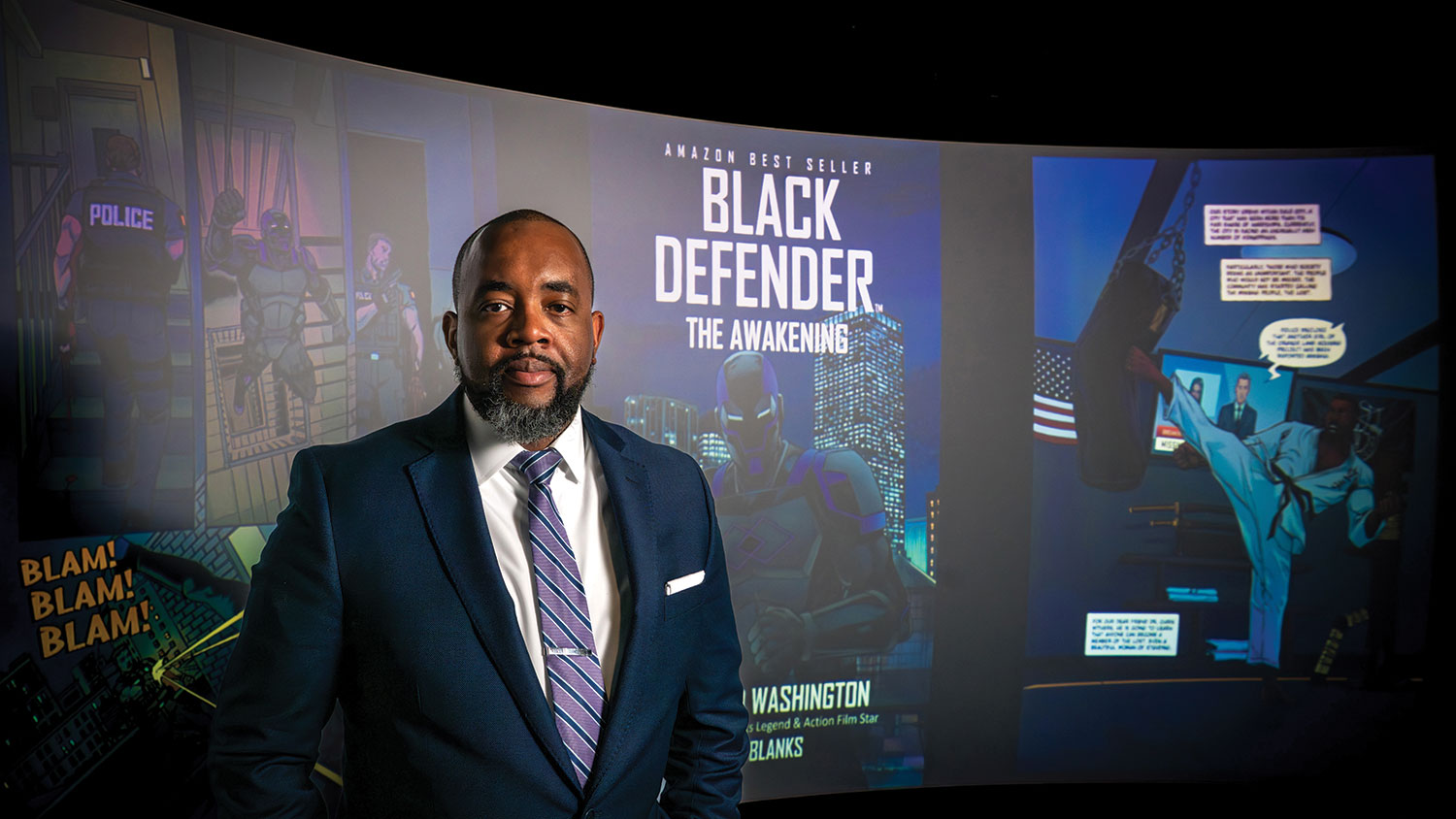 Comic book author David Washington stands in front of the image of his award-winning graphic novel Black Defender: The Awakening.