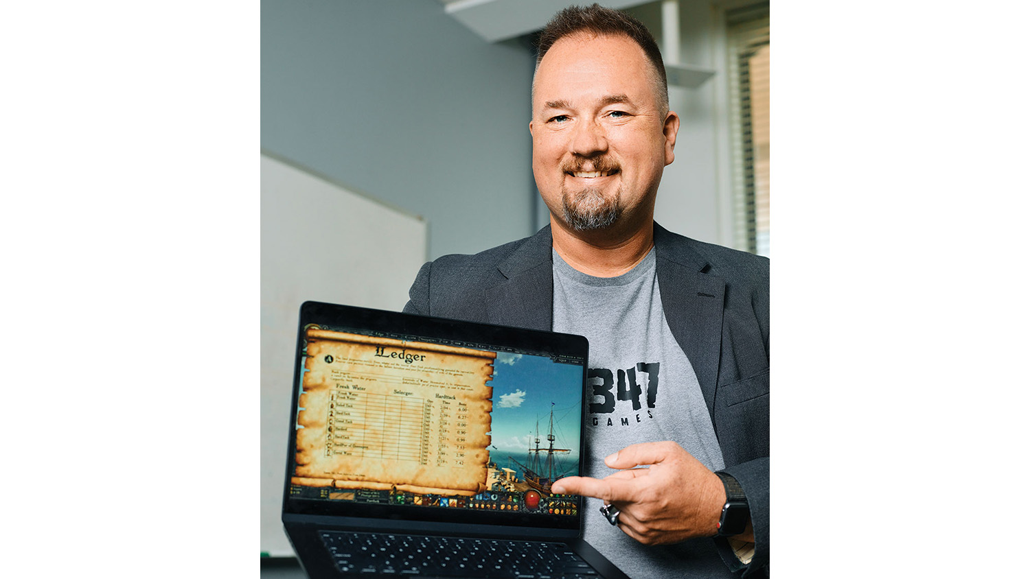 Mike Prelaske displays a computer featuring a game he designed to help with learning.