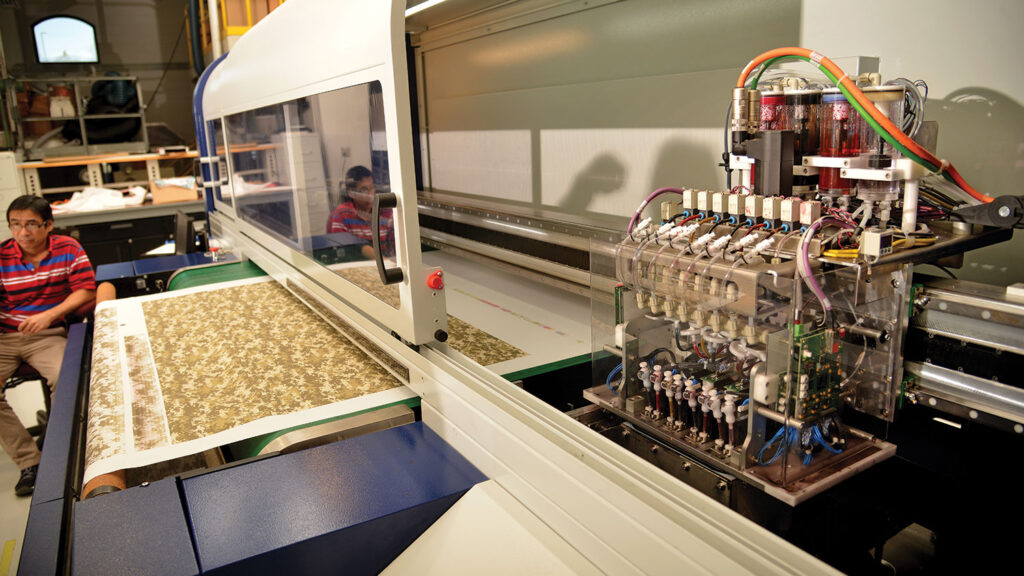 An digital printer operates on fabric in a textile laboratory.