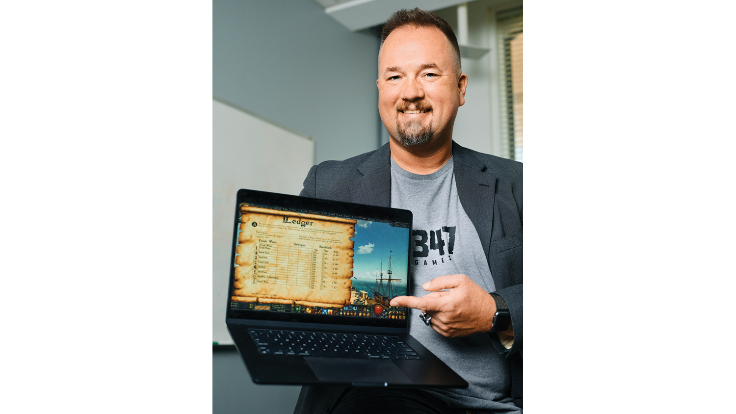 Mike Prelaske displays a computer featuring a game he designed to help with learning.